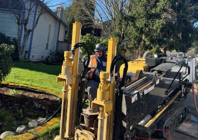 Man operating a large yellow directional drill.