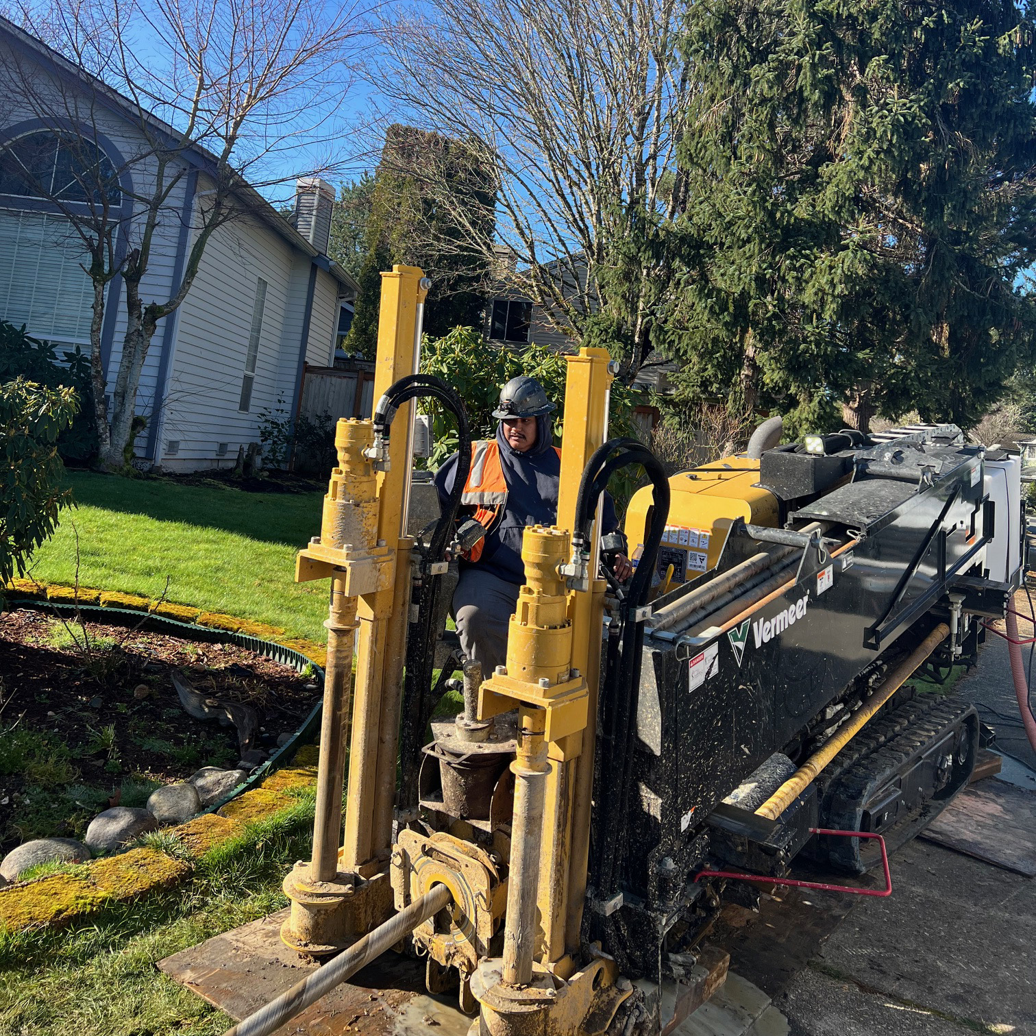 Man operating a large yellow directional drill.