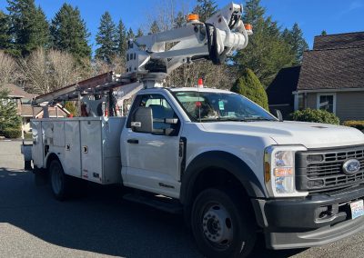 Large white truck with aerial lift.