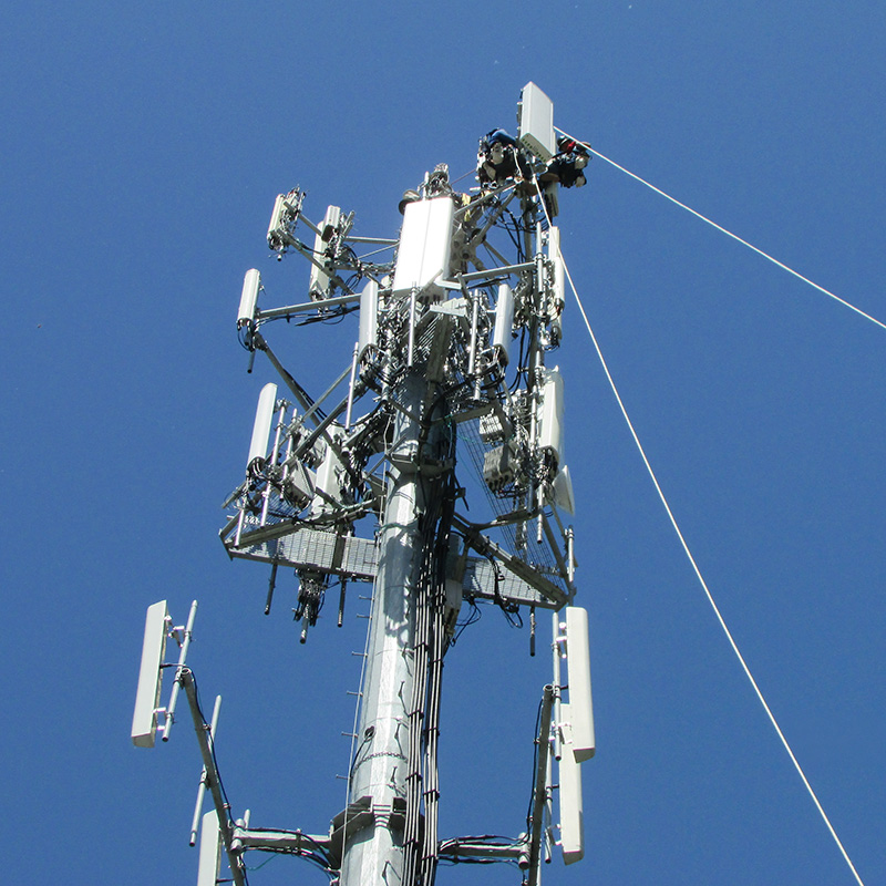 Top of a cell tower with wires.