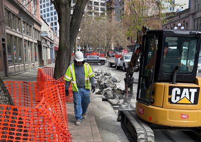 Excavator working in a downtown street.