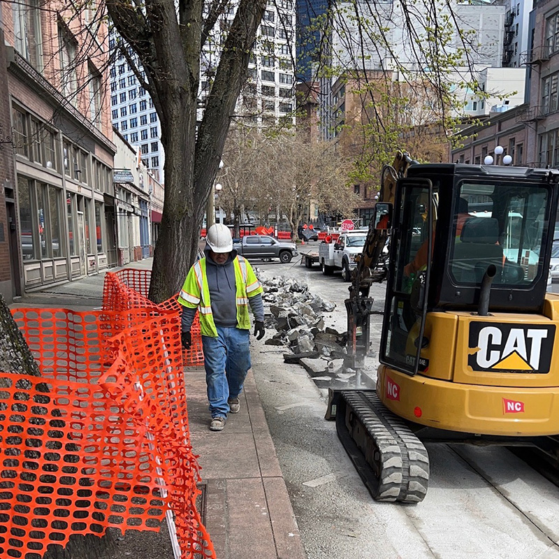 Excavator working in a downtown street.
